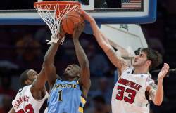 Louisville Cardinals' Jennings and Marra block a shot by Marquette Golden
Eagles' Johnson-Odom during the second half of their NCAA men's basketball game...