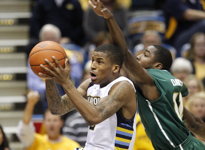 Marquette's Vander Blue makes a lay up on a fast break despite the efforts of
Jacksonville's Chris Davis during the second half of their game Monday, November
28, 2011 at the Bradley Center in Milwaukee, Wis.  MARK...