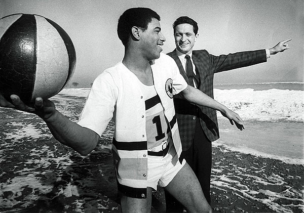 Pat Smith prepares to toss the basketball into Lake Michigan as Al Mcguire...
